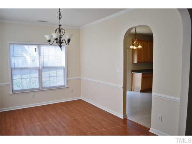 8501 Neuse Hunter Drive Raleigh, NC 27616 - Photo 5 of 16 an empty room with wooden floor cabinet and windows