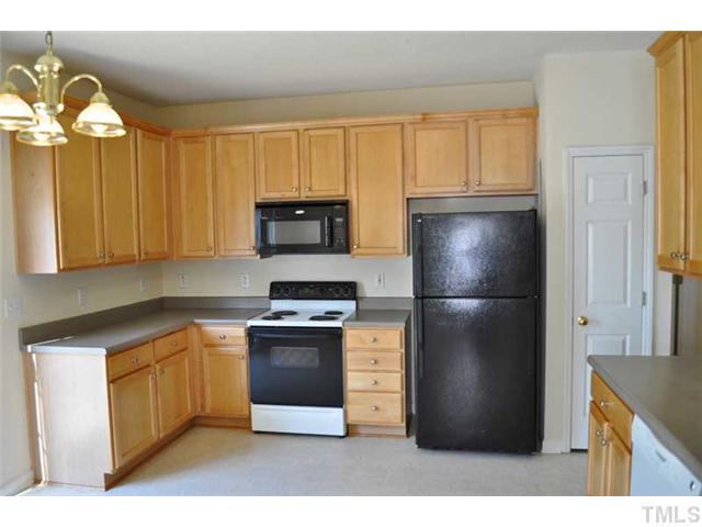 8501 Neuse Hunter Drive Raleigh, NC 27616 - Photo 7 of 16 a kitchen with stainless steel appliances granite countertop a refrigerator a stove a sink and a microwave