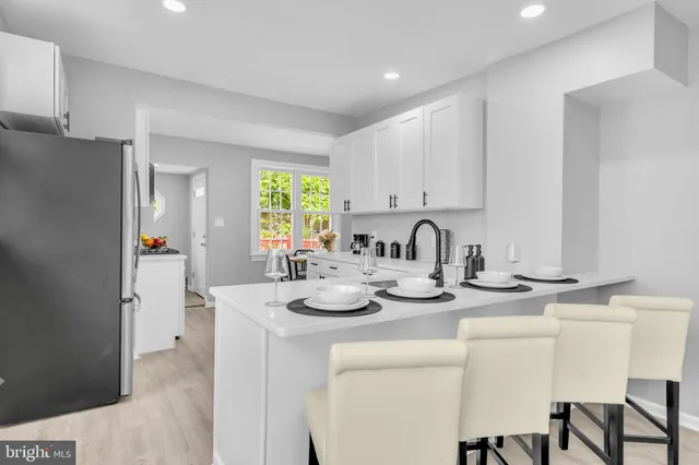 a kitchen with appliances a sink and cabinets