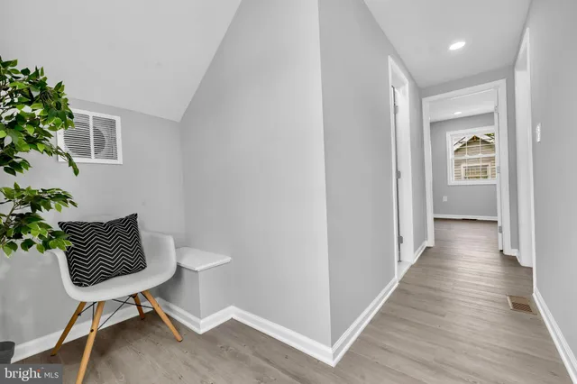 a view of a workspace with furniture and wooden floor