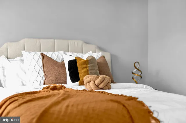 a bedroom with a bed and lamp