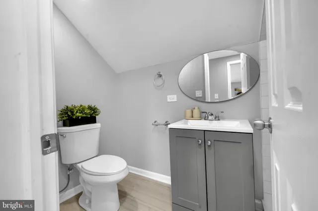 a bathroom with a toilet a sink and mirror