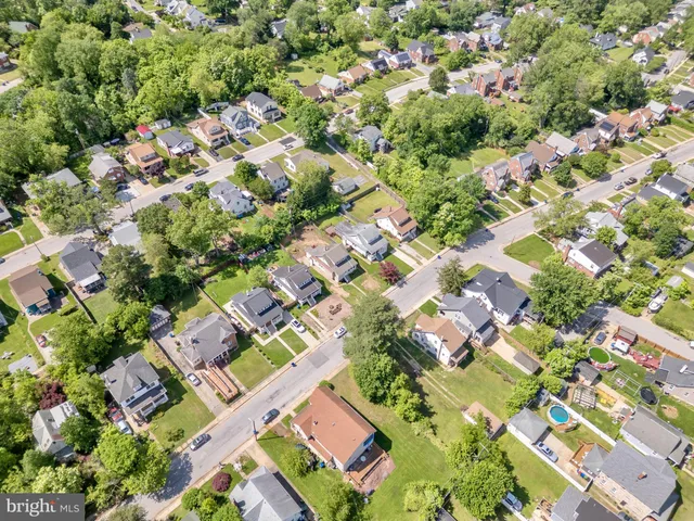 an aerial view of a residential houses with swimming pool and outdoor space