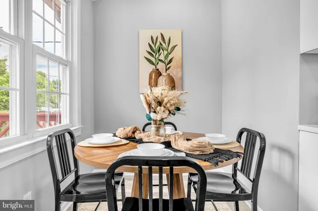 a dining room with furniture and wooden floor