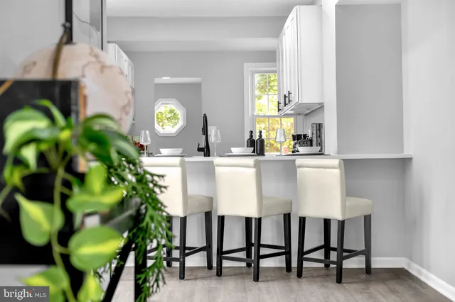 a dining room with furniture and a clock