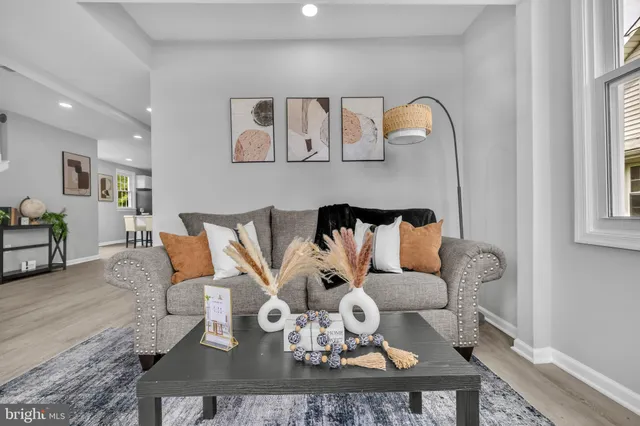 a living room with furniture a couch and dresser