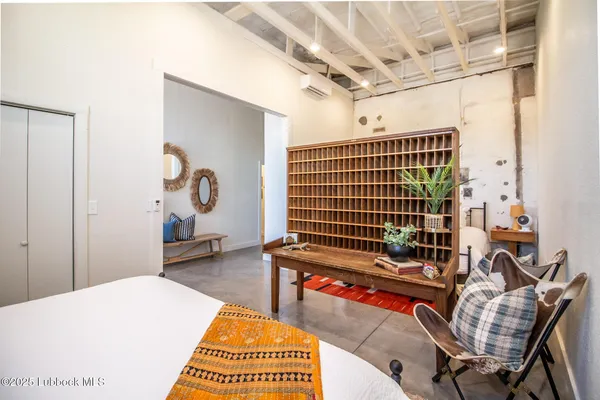 a bedroom with a bed and a table in it