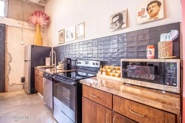 a kitchen with stainless steel appliances granite countertop a stove and a sink