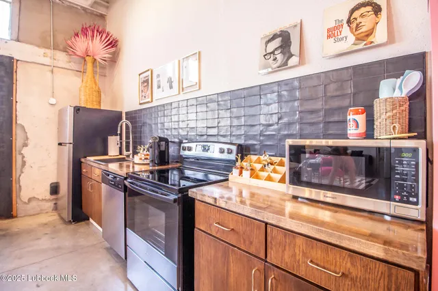 a kitchen with stainless steel appliances granite countertop a stove and a sink