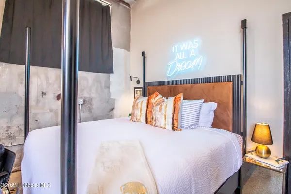 a bed room with a bed and a large window