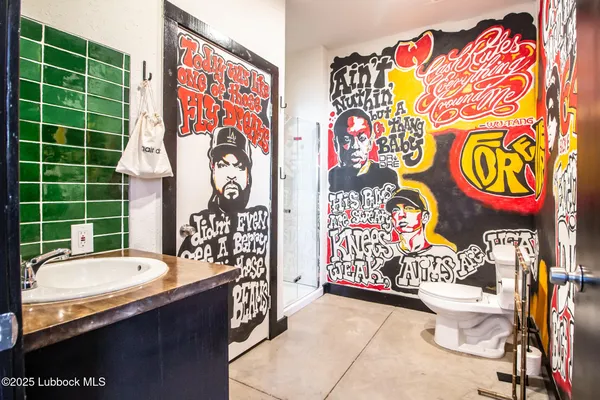a bathroom with a toilet and a shower curtain