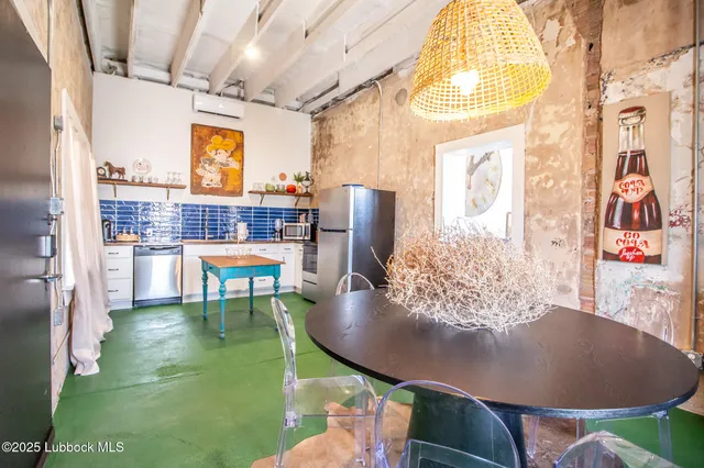 a dining room with furniture and a floor to ceiling window