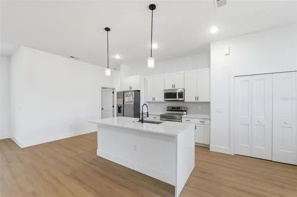 a kitchen with stainless steel appliances a refrigerator sink and stove