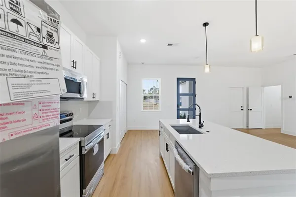 an empty room with windows and closet