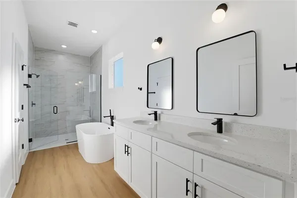 a white bath tub sitting next to a shower