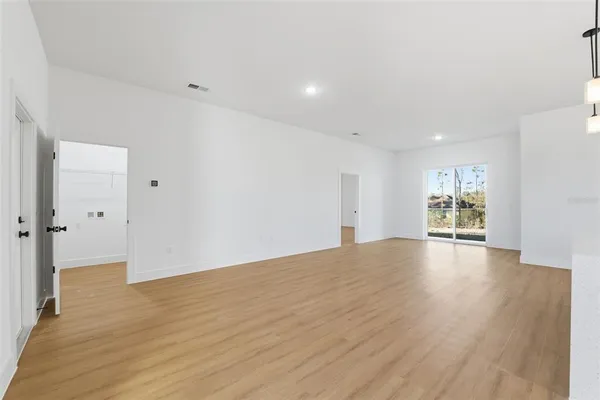 a view of kitchen with kitchen island wooden floor and center island