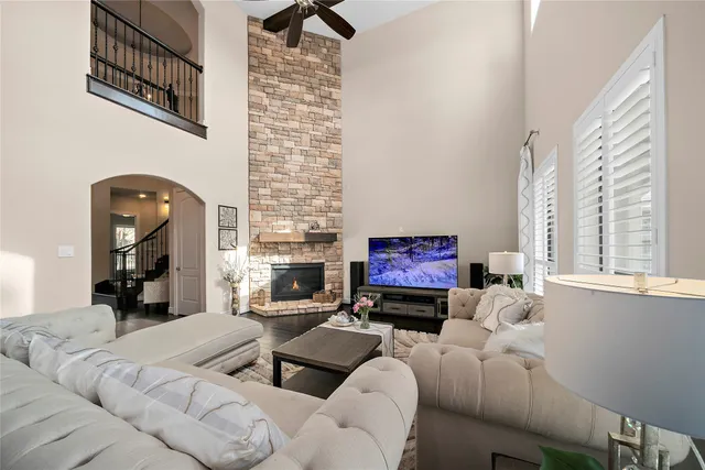 a living room with furniture a flat screen tv and a fireplace