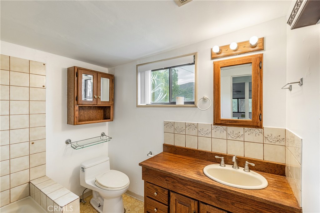 7444 Tranquil Drive Tujunga, CA 91042 - Photo 11 of 34 a bathroom with a sink a toilet and mirror