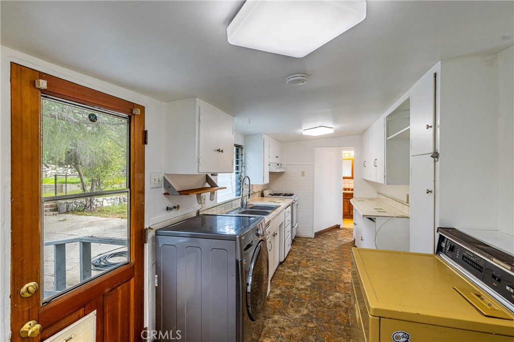 7444 Tranquil Drive Tujunga, CA 91042 - Photo 15 of 34 a kitchen with a sink stove and cabinets