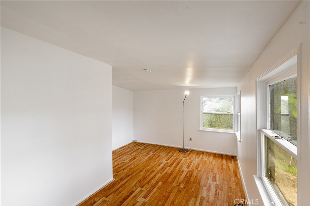 7444 Tranquil Drive Tujunga, CA 91042 - Photo 9 of 34 wooden floor in an empty room with a window