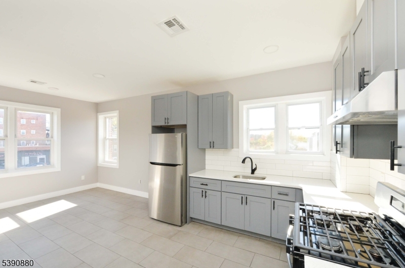 9 Watsessing Avenue, Unit 2R Bloomfield, NJ 07003 - Photo 4 of 14 a kitchen with a sink and a refrigerator