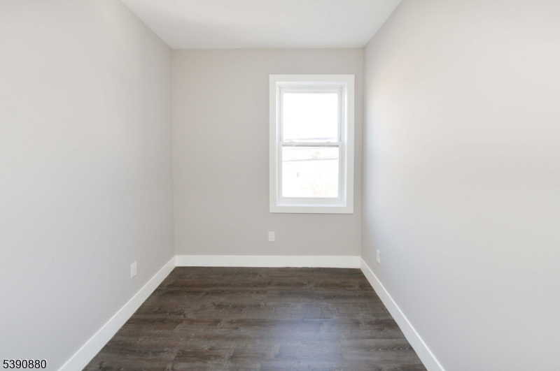 9 Watsessing Avenue, Unit 2R Bloomfield, NJ 07003 - Photo 6 of 14 an empty room with wooden floor and windows