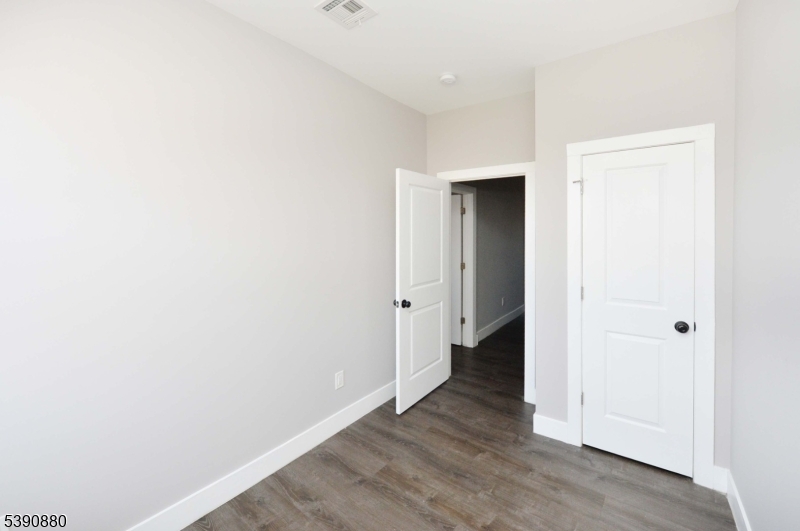 9 Watsessing Avenue, Unit 2R Bloomfield, NJ 07003 - Photo 7 of 14 a view of a hallway with wooden floor