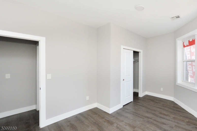 9 Watsessing Avenue, Unit 2R Bloomfield, NJ 07003 - Photo 8 of 14 an empty room with wooden floor and windows