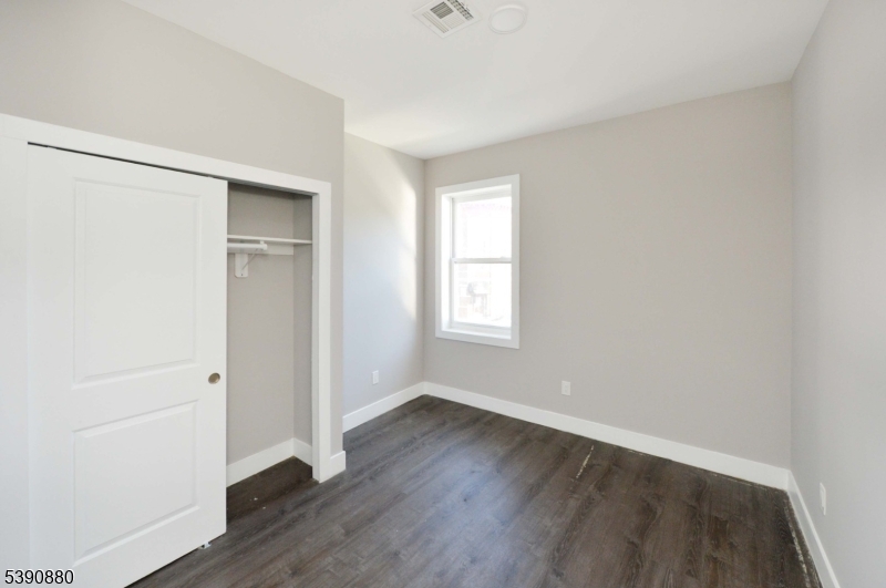 9 Watsessing Avenue, Unit 2R Bloomfield, NJ 07003 - Photo 9 of 14 an empty room with wooden floor