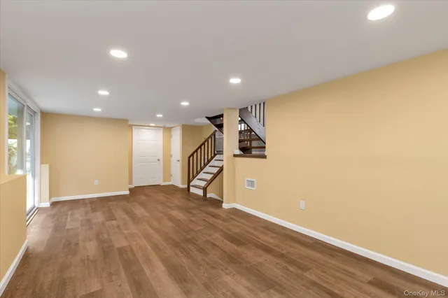 a view of a room with wooden floor and stairs