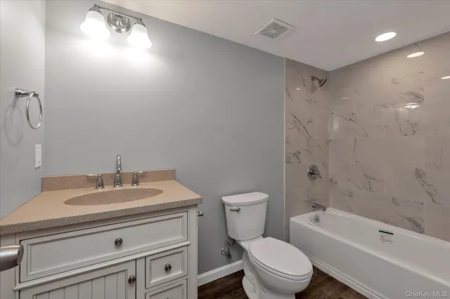 a bathroom with a sink a toilet and a bathtub