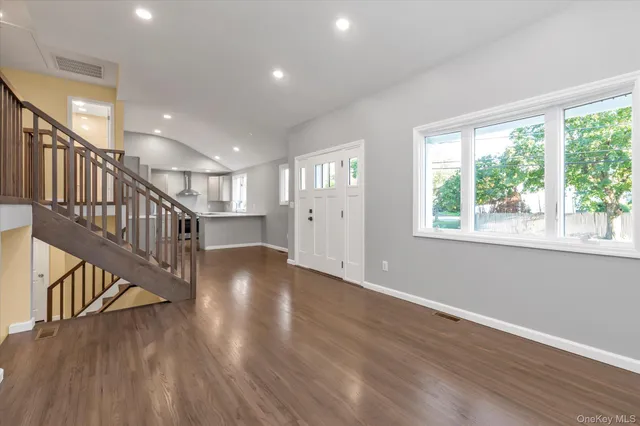 a view of an entryway with wooden floor and windows