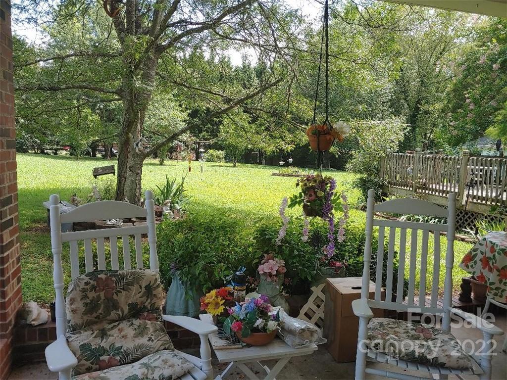 4016 Puetts Chapel Road Dallas, NC 28034 - Photo 18 of 22 a backyard of a house with lots of green space and outdoor seating