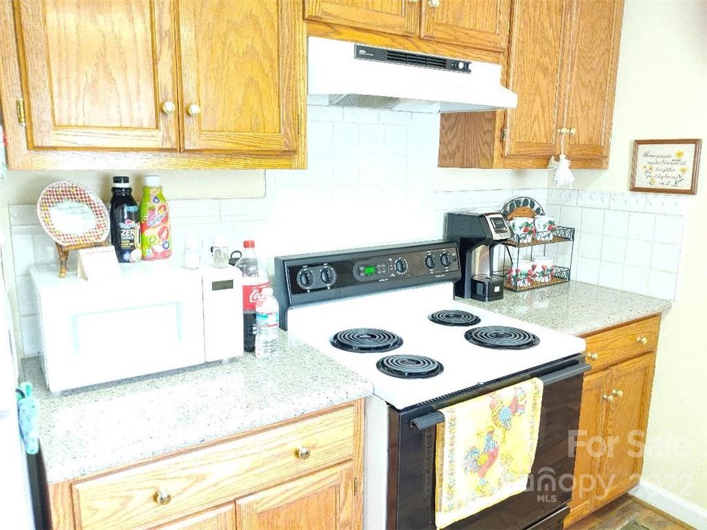 4016 Puetts Chapel Road Dallas, NC 28034 - Photo 5 of 22 a kitchen with a sink a stove and a microwave