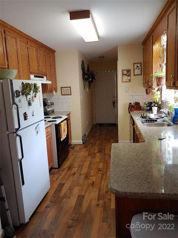 4016 Puetts Chapel Road Dallas, NC 28034 - Photo 6 of 22 a kitchen with granite countertop a refrigerator stove and sink