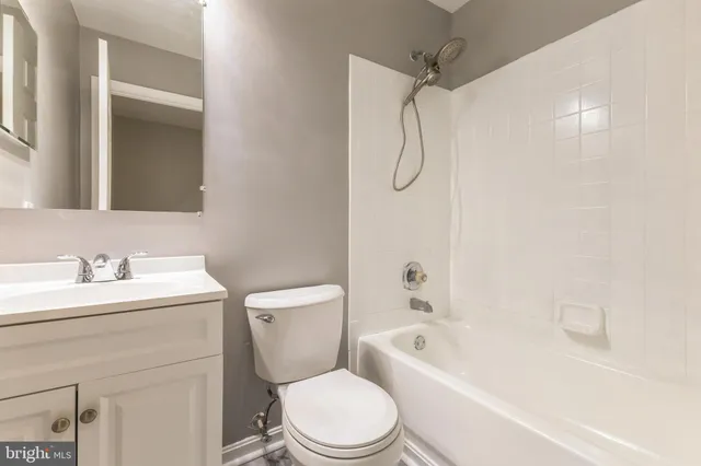 a bathroom with a toilet sink vanity shower and bathtub