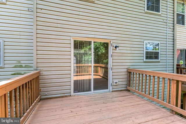 a view of a backyard with large trees and a barn