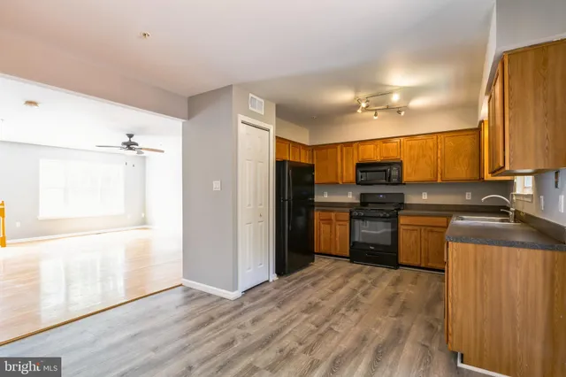 a kitchen with a refrigerator and a stove top oven