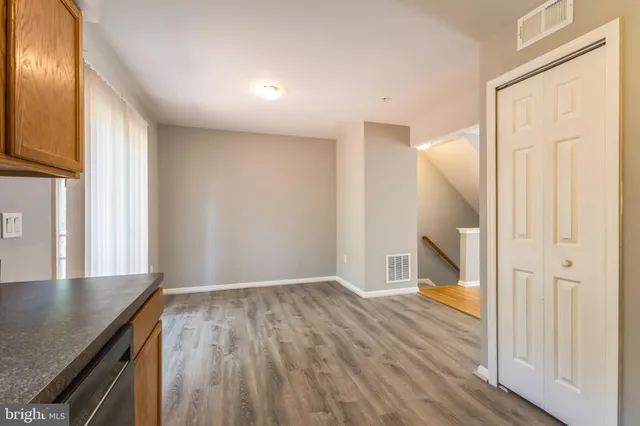 a view of a livingroom with wooden floor and staircase