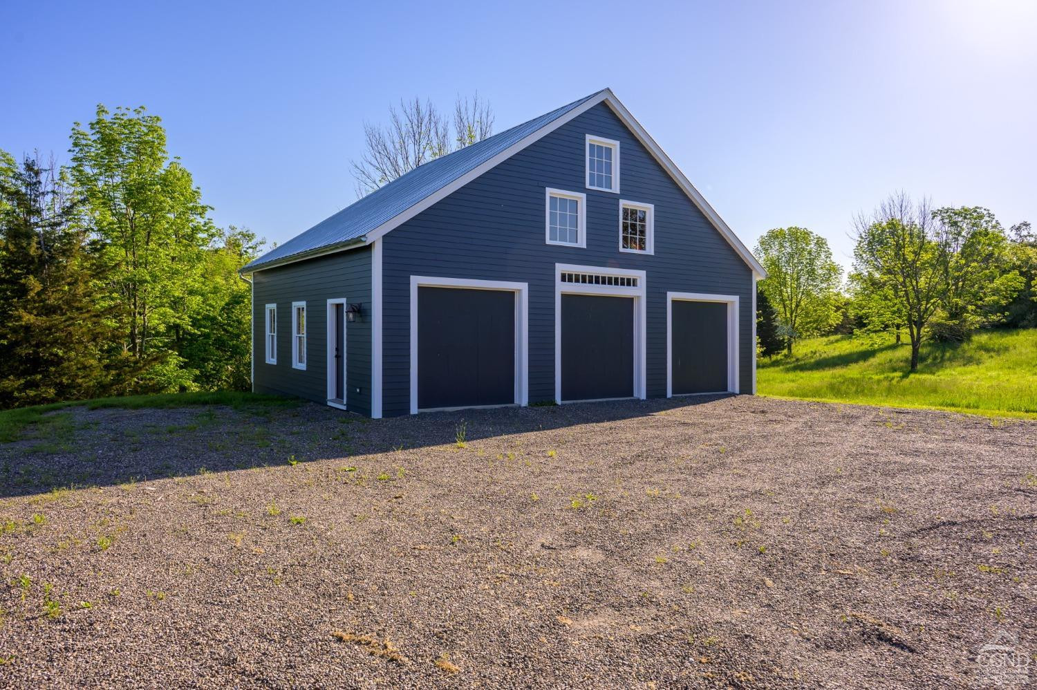 38 Miller Farm Road Claverack, NY 12413 - Photo 25 of 37 a front view of a house with a yard and garage