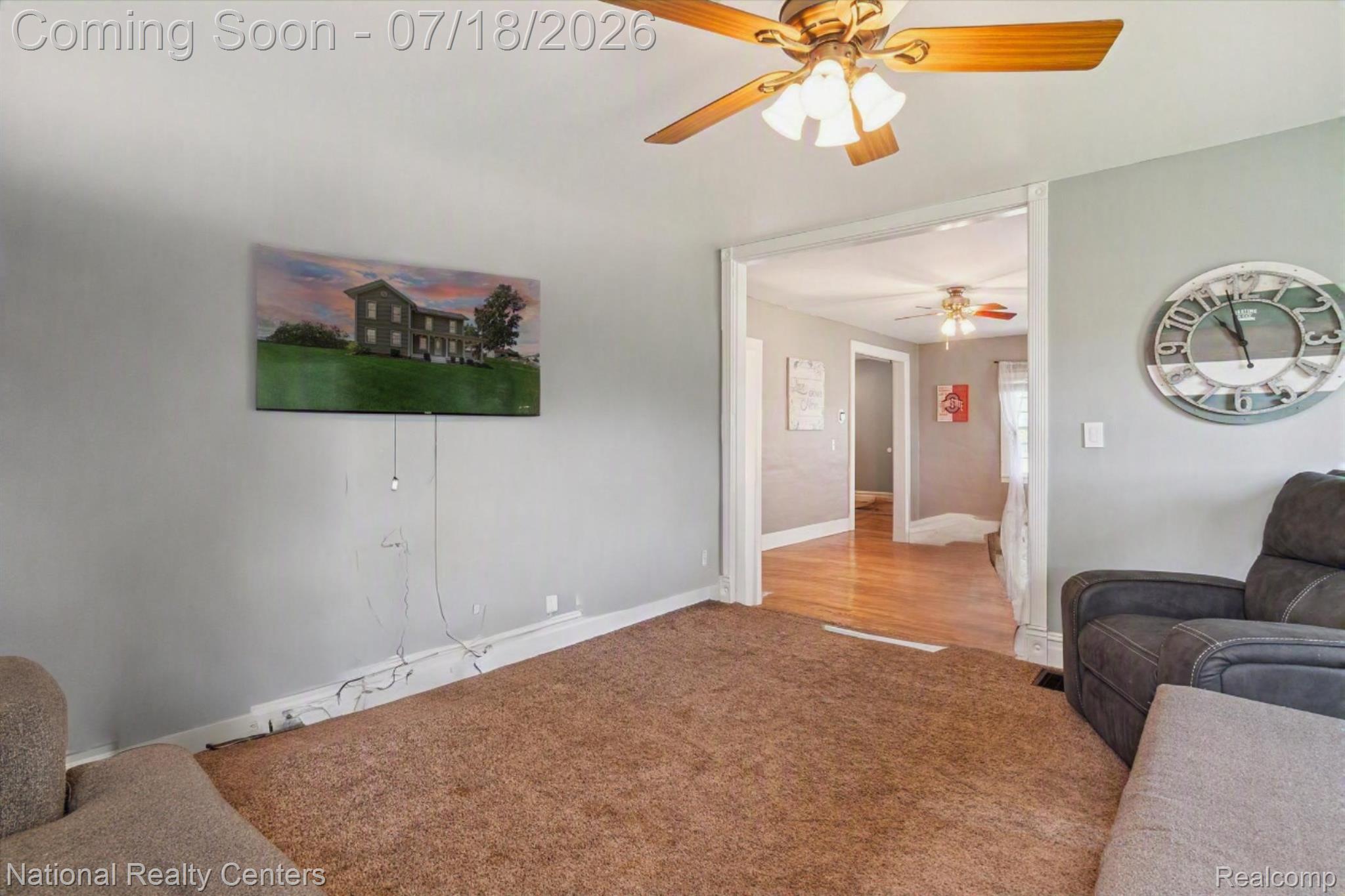 9589 Clinton Macon Road Tecumseh, MI 49286 - Photo 10 of 48 Carpeted room featuring a ceiling fan with integrated lighting, framed doorway, and light gray wall paint