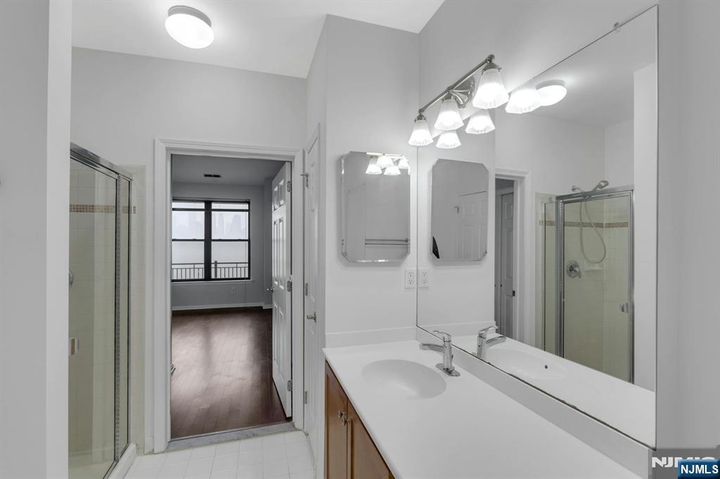 24 Ave At Port Imperial, Unit 401 West New York, NJ 07093 - Photo 12 of 27 a en suite bathroom with a double vanity sink a mirror and shower