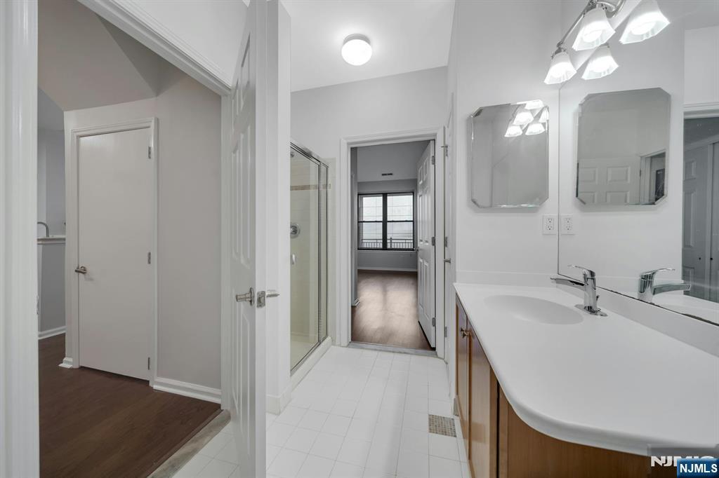 24 Ave At Port Imperial, Unit 401 West New York, NJ 07093 - Photo 13 of 27 a en suite bathroom with a sink and a mirror