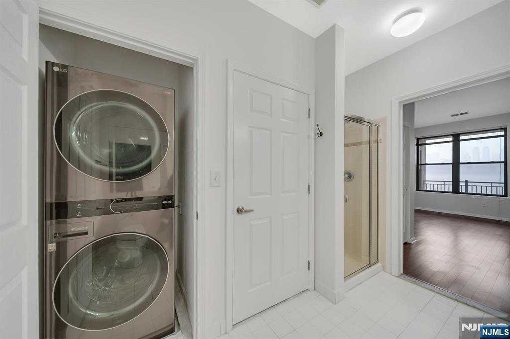 24 Ave At Port Imperial, Unit 401 West New York, NJ 07093 - Photo 14 of 27 a view of a hallway with washer and dryer