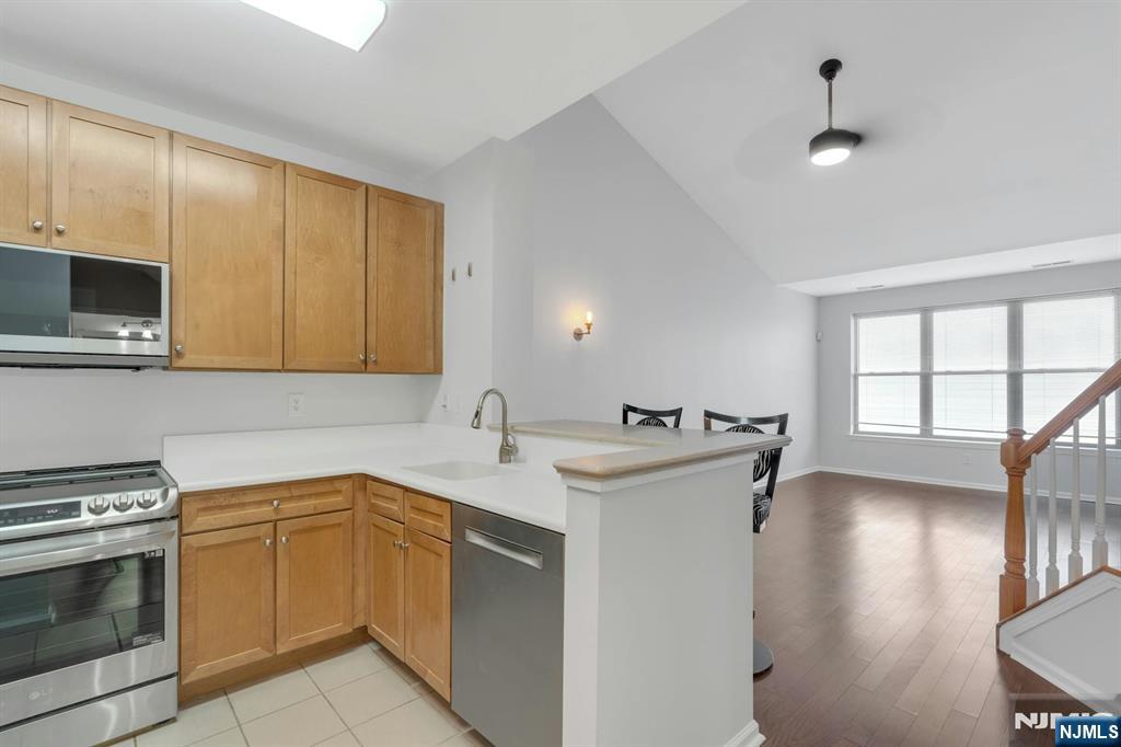 24 Ave At Port Imperial, Unit 401 West New York, NJ 07093 - Photo 2 of 27 a kitchen with a sink stove and microwave