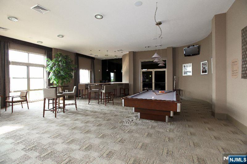 24 Ave At Port Imperial, Unit 401 West New York, NJ 07093 - Photo 23 of 27 a living room with furniture large window and flat screen tv