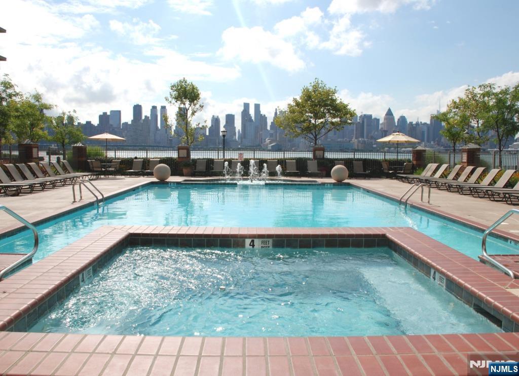 24 Ave At Port Imperial, Unit 401 West New York, NJ 07093 - Photo 25 of 27 a view of a swimming pool with outdoor seating