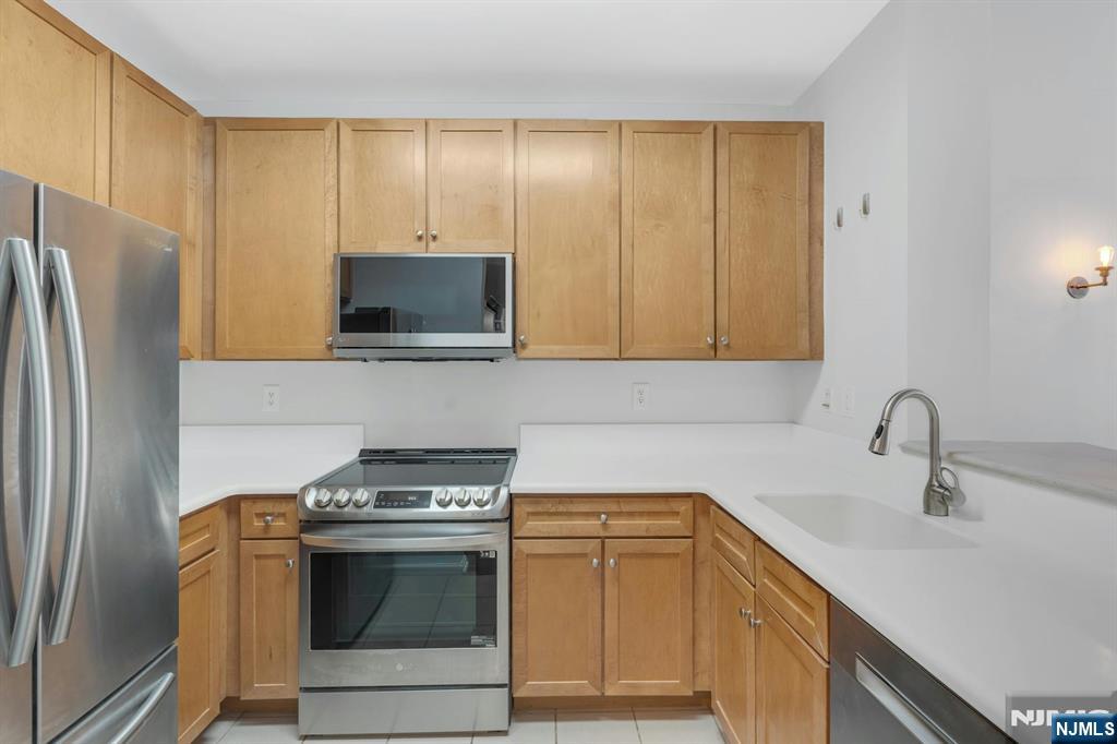 24 Ave At Port Imperial, Unit 401 West New York, NJ 07093 - Photo 3 of 27 a kitchen with a sink stove and refrigerator