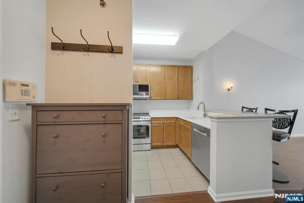 24 Ave At Port Imperial, Unit 401 West New York, NJ 07093 - Photo 4 of 27 a kitchen with refrigerator cabinets and a sink