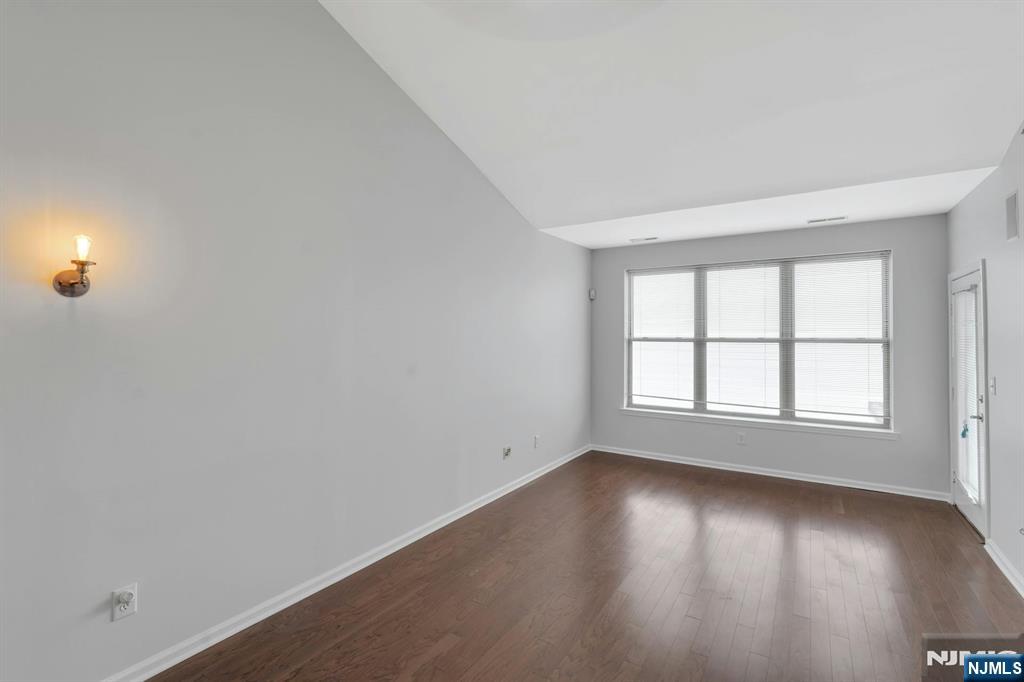 24 Ave At Port Imperial, Unit 401 West New York, NJ 07093 - Photo 5 of 27 an empty room with wooden floor and windows